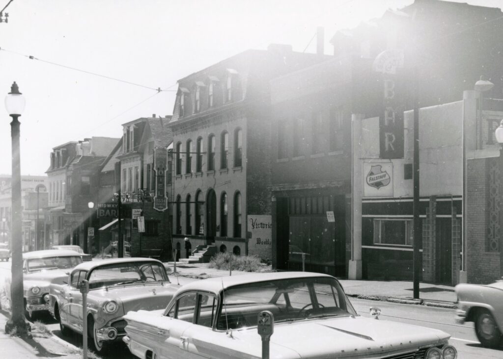 The south side of the 3500 block of Olive in the early 1960s. Several popular lesbian and gay hangouts are visible: Shelley’s Midway Bar, Act IV Coffeehouse, and the Golden Gate Bar (left to right). Another gay bar, the Onyx Room, is out of the frame to the right. All of these buildings were later demolished. Image courtesy of the Missouri History Museum. 