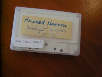 Photo of a cassette holding the recording of a reading by the poet Howard Nemerov from the River Styx Archive.