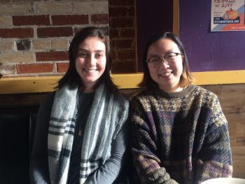 2 female students seated.