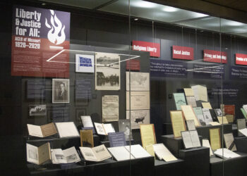 "Liberty and Justice for All: ALCU of Missouri, 1920-2020" exhibition behind glass display case.