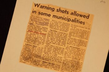 Newspaper clipping with an article headline reading "Warning shots allowed in some municipalities" 