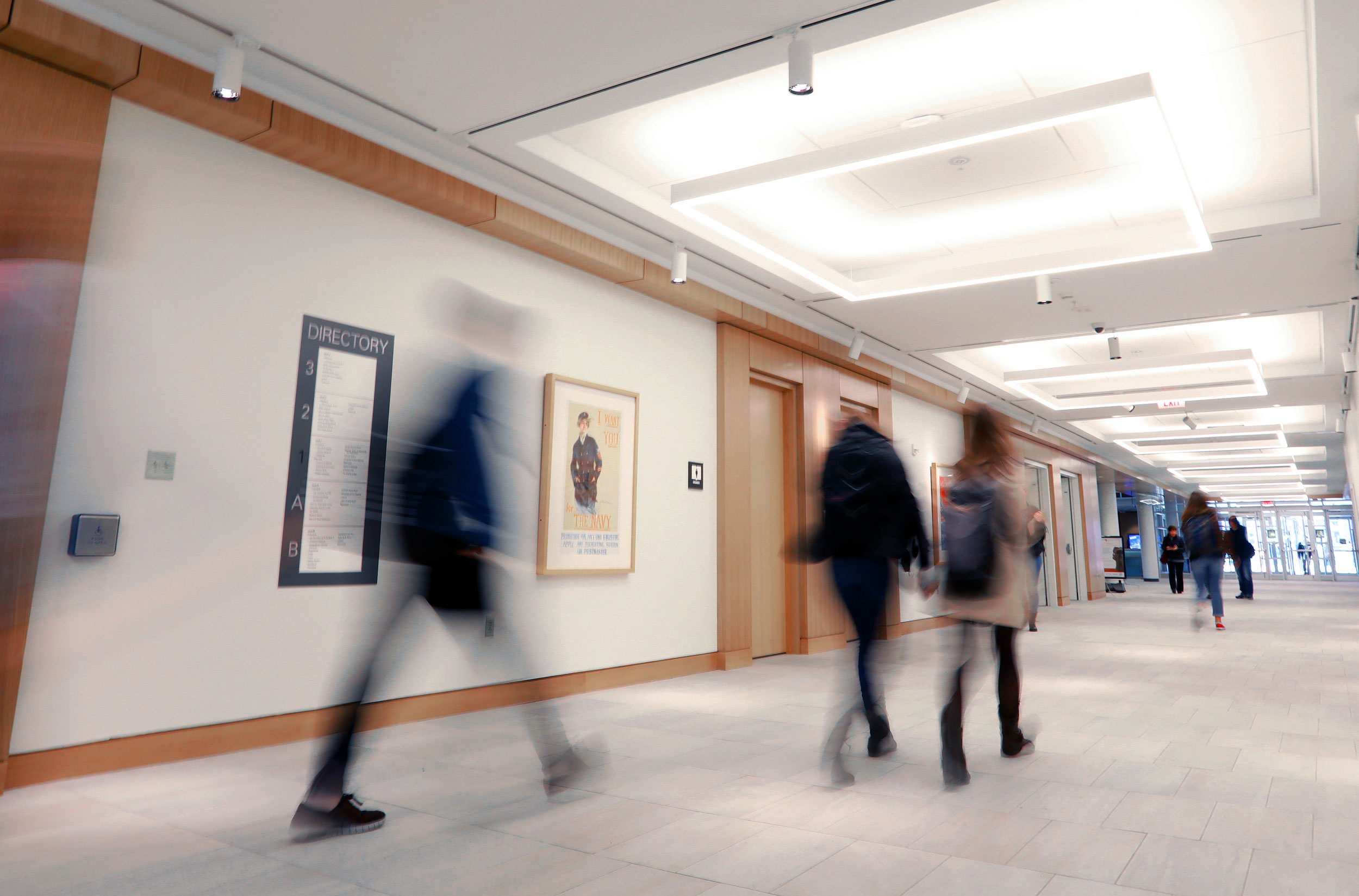 Motion blurred students walking through a hallway in Olin Library.