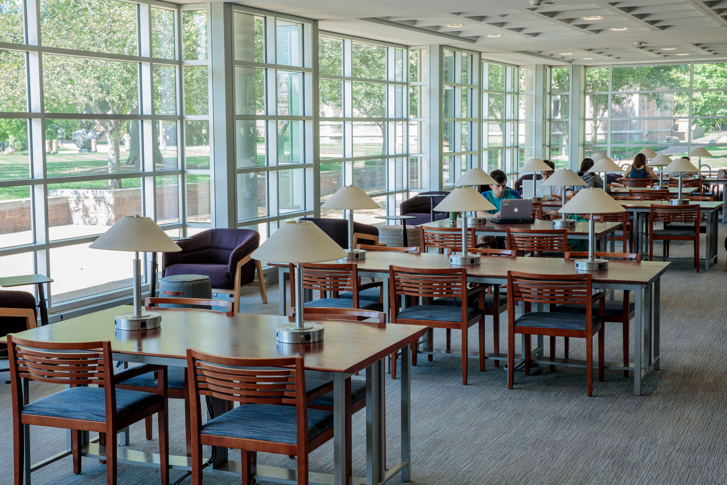 Photo of students using the study tables in Olin Library