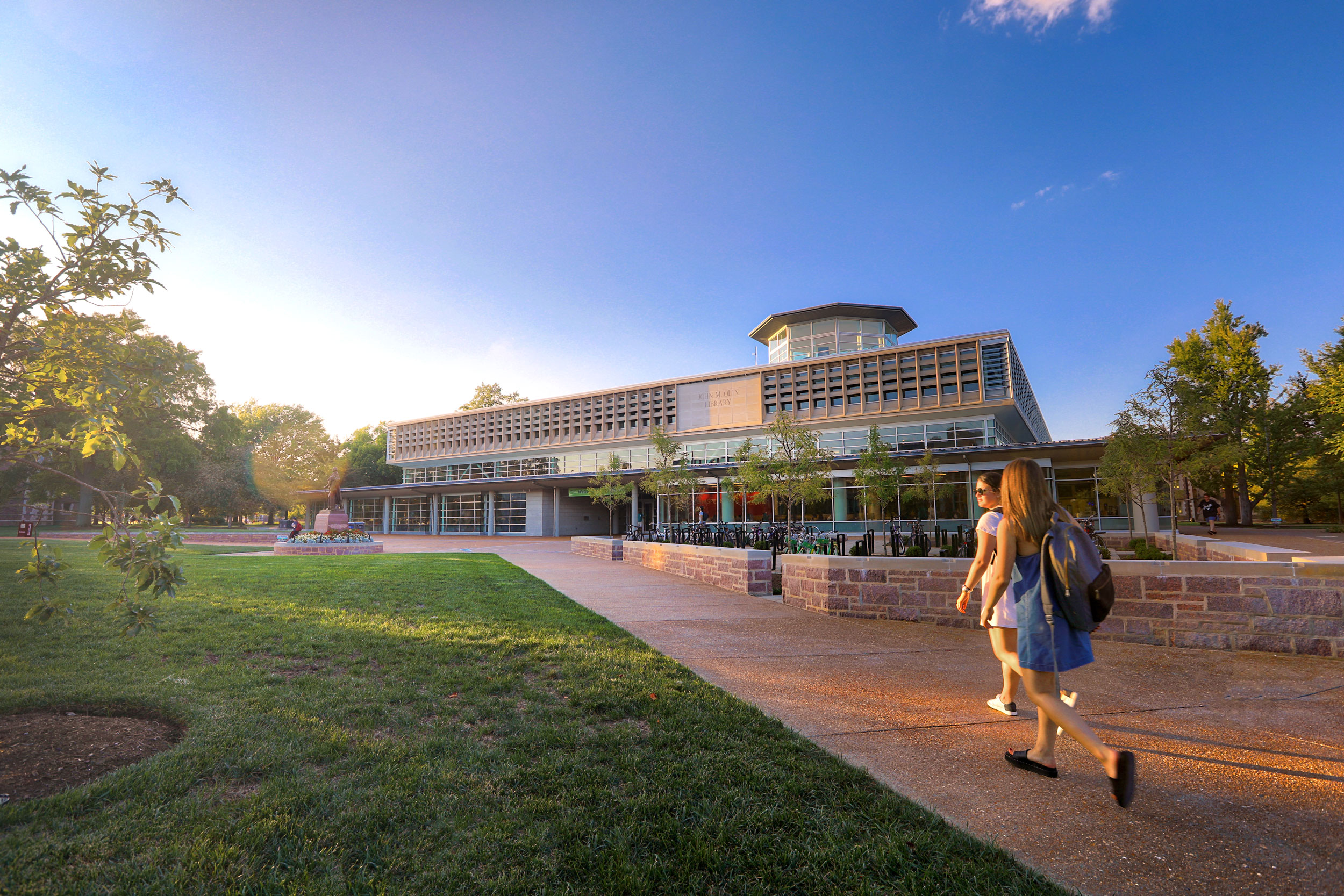 Students on the sidewalk leading to Olin Library.