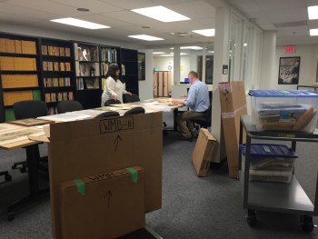 Two staff members sorting through the Baumhofer Collection shipment. 