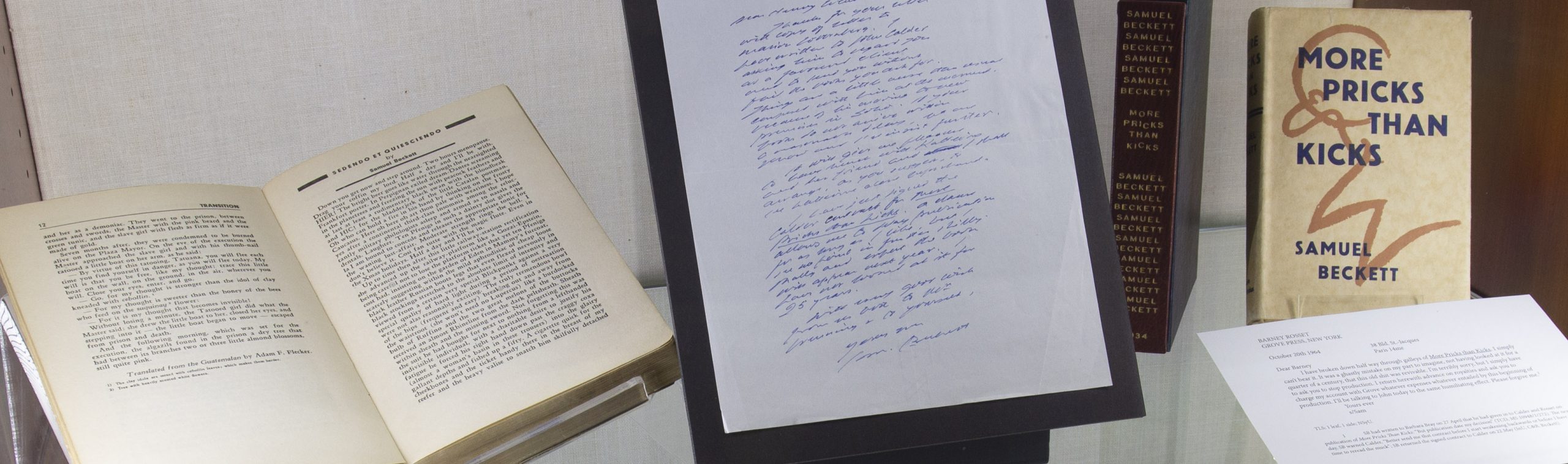 Books and a handwritten note on display in the "If you could finish it..." exhibition.