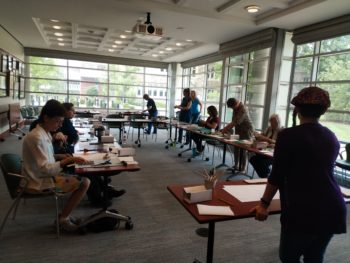 Students during a class hosted in the Julian Edison Department Mendel Classroom of Special Collections.