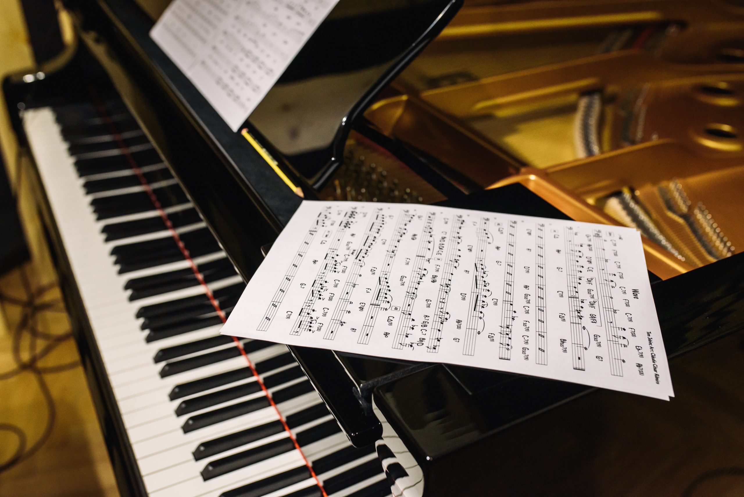 Musical notes sitting on top of a piano.