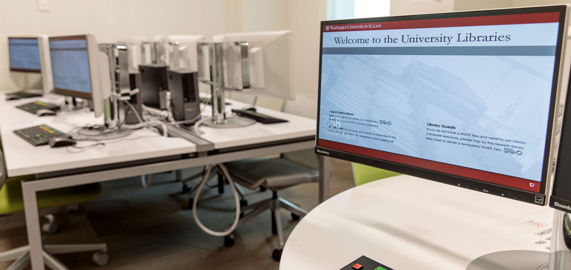 Kopolow Library Bloomberg Lab with computer terminals and wheeled chairs at stationary tables.