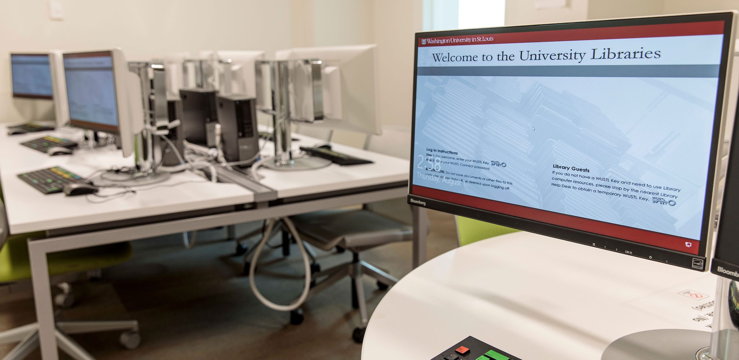 Kopolow Library Bloomberg Lab with computer terminals and wheeled chairs at stationary tables.