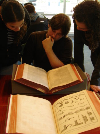 Students viewing the Diderot Encyclopedia in the Special Collections classroom.