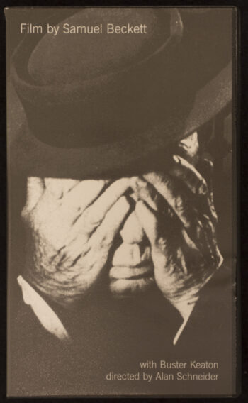 The VHS cover of Film depicts the face of a man in a top hat being covered by his own two hands with is nose and mouth remaining visible. 