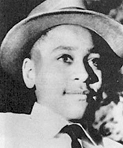 A photo of young Emmett Till in a brimmed hat, collared shirt, and tie taken by his mother in 1954 about eight months before his murder. 