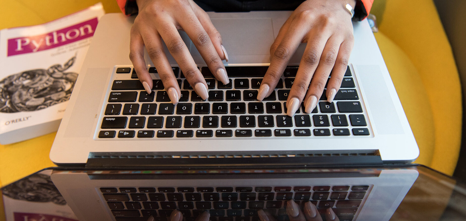 A student typing on a laptop.