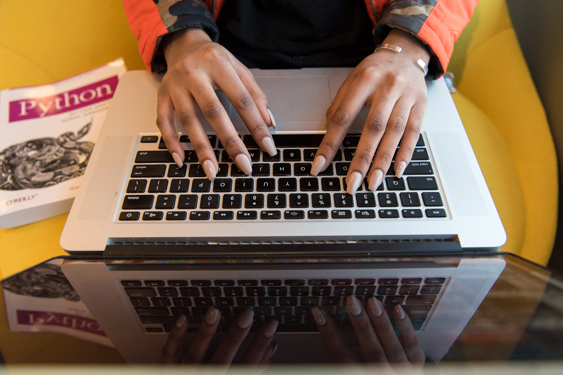 A student typing on a laptop.