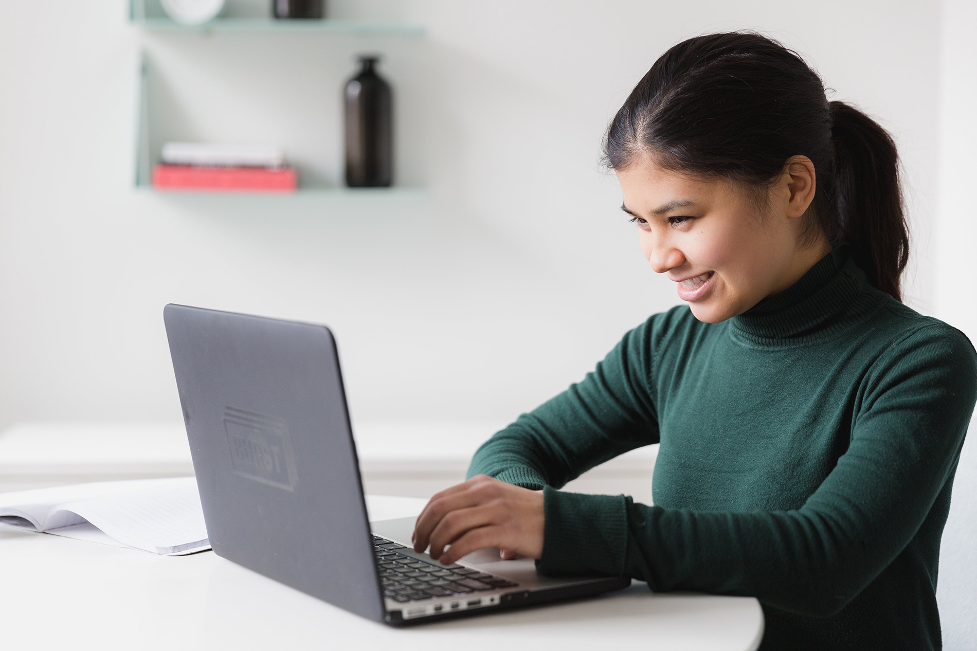 A student at a laptop.