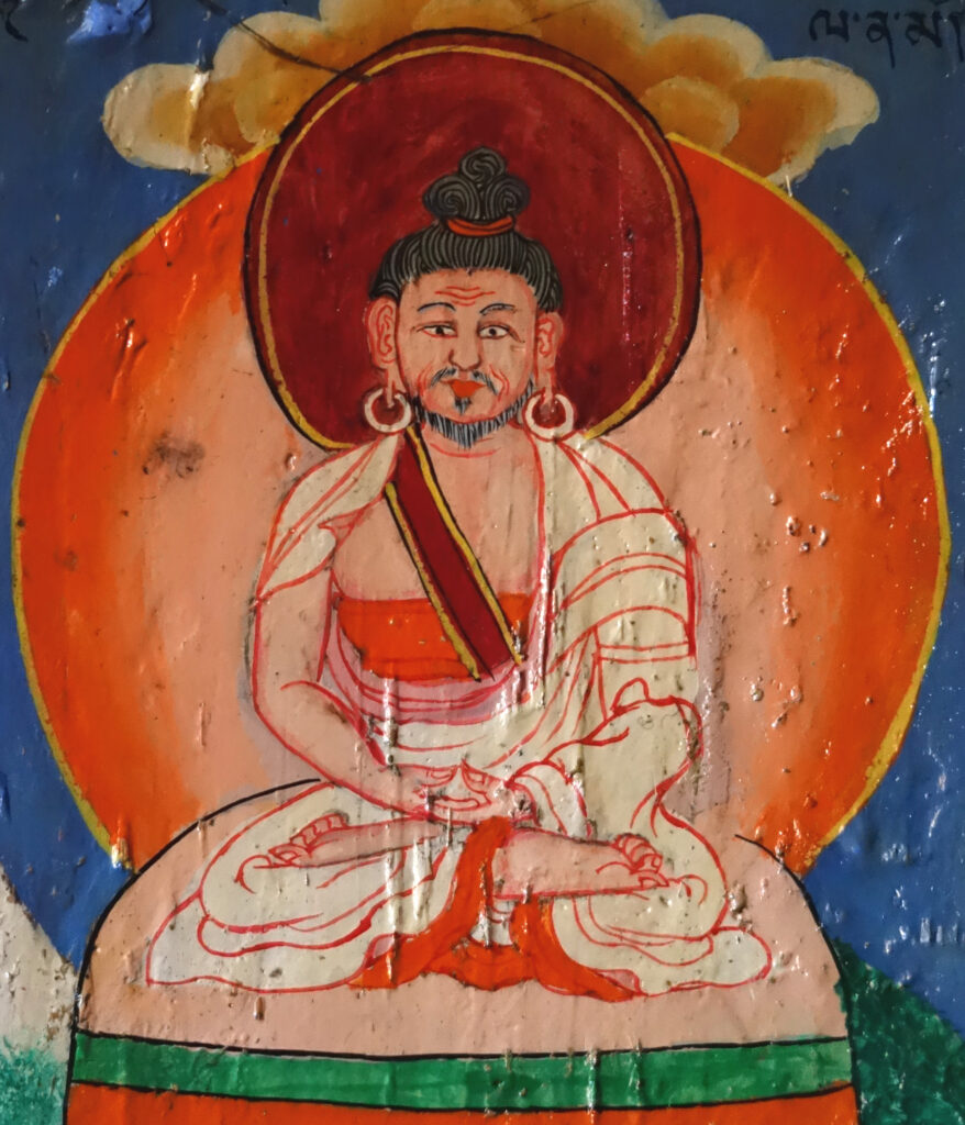 A colorful painting of a Buddhist monk sitting in the lotus position.