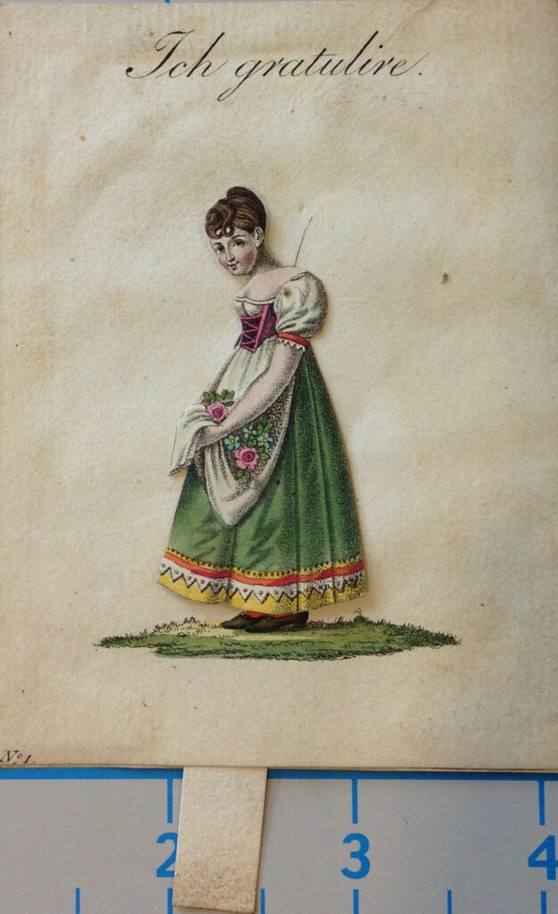 The girl on the card has her hair in an intricate updo and is holding a bouquet of flowers in the apron over her dress.