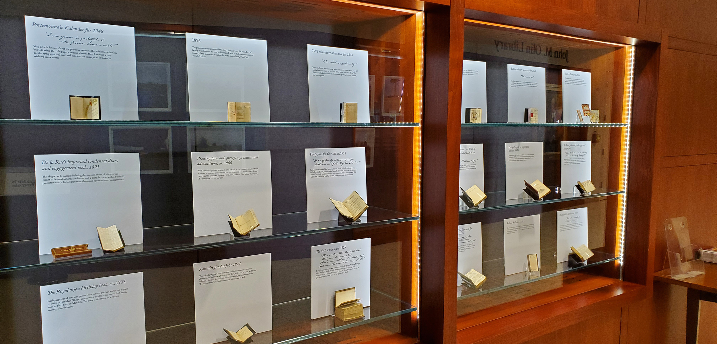 Header image for the A Day in the Life exhibition. The image is of the display case housing the miniature books that are part of the collection on display.