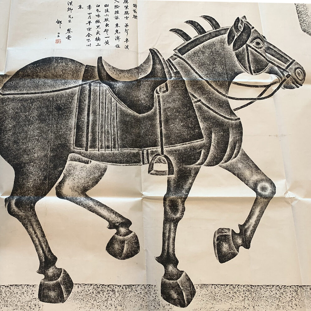 Painted depiction of a Chinese war horse. The painting is in black and white and uses negative space to provide definition to the horse.