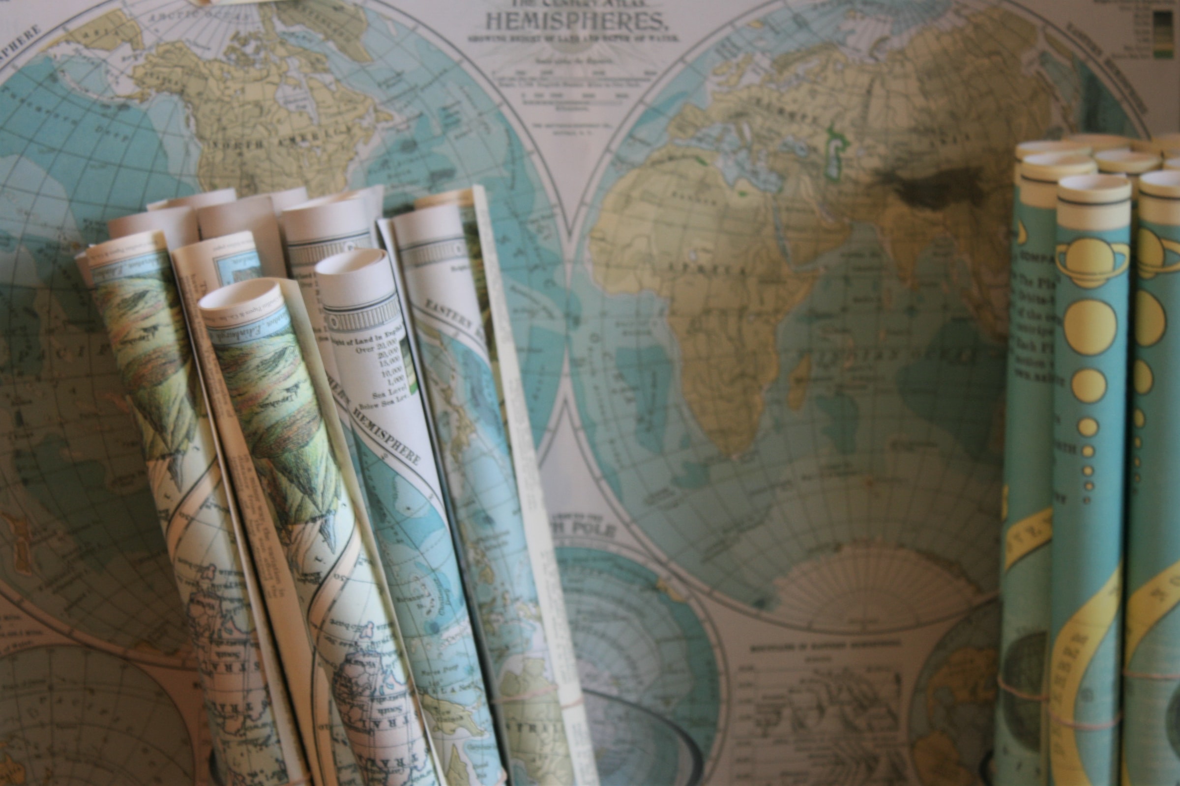 Stock image of rolled and flat maps.