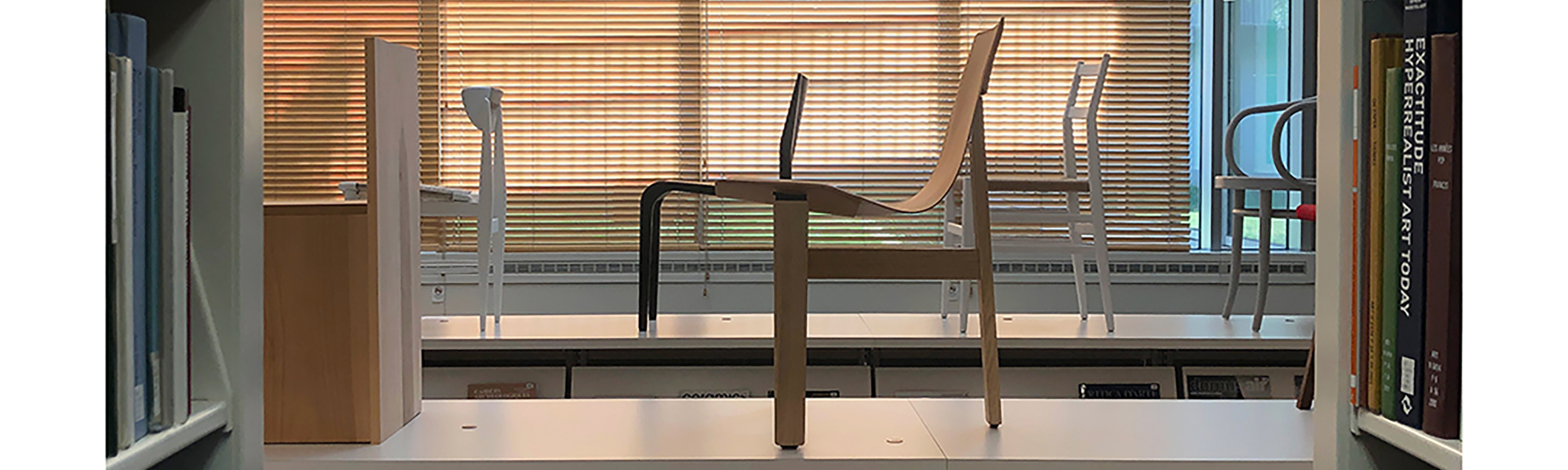 Photo of the chairs on top of the shelves on display in the Art & Architecture Library.