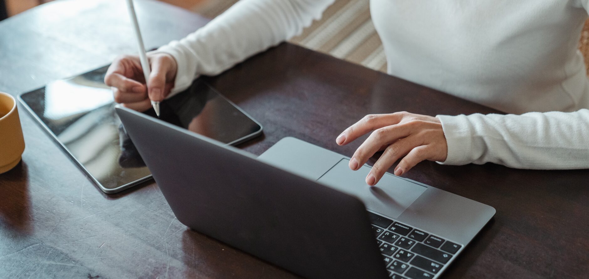 A student using a laptop and tablet to study.