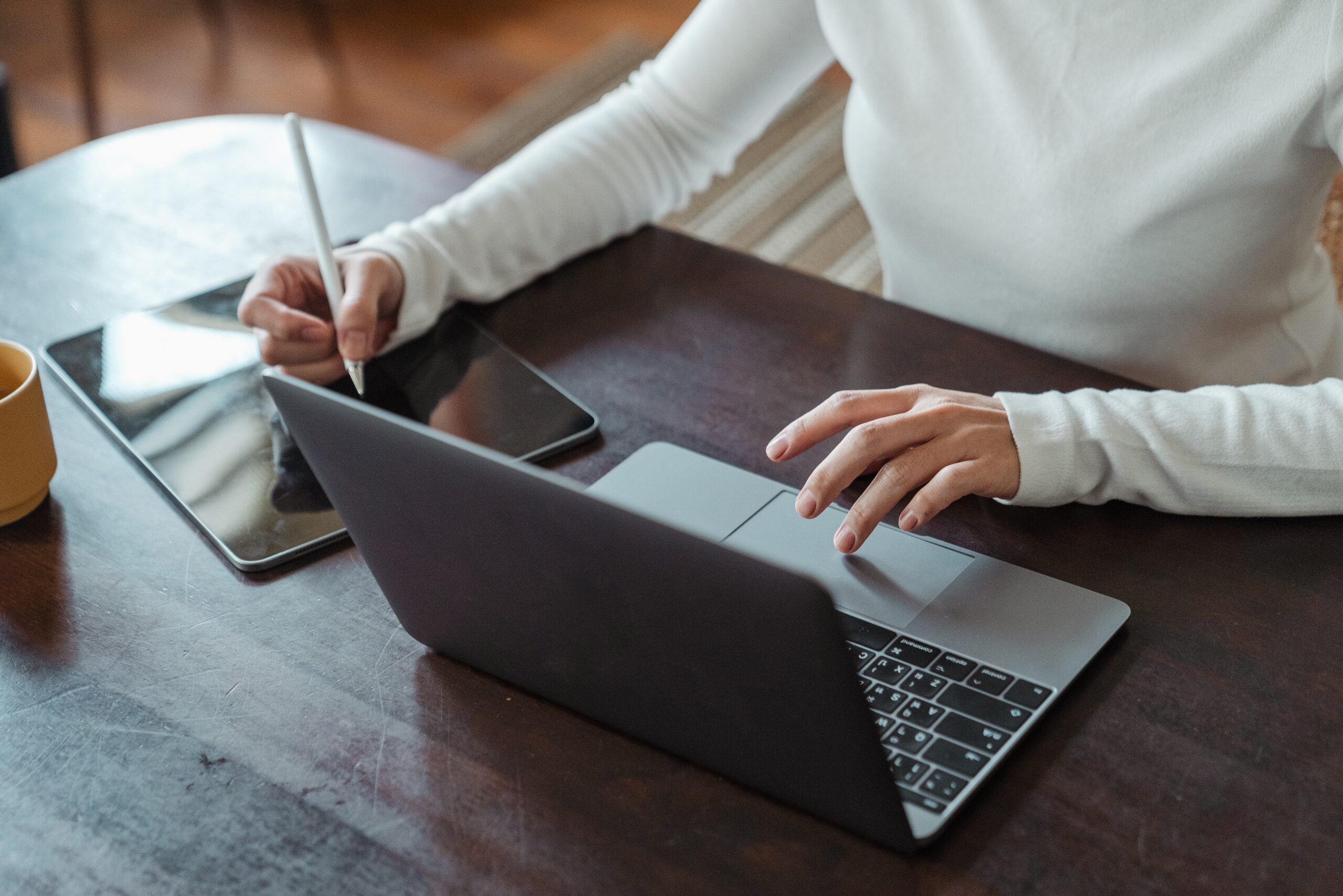 A student using a laptop and tablet to study.