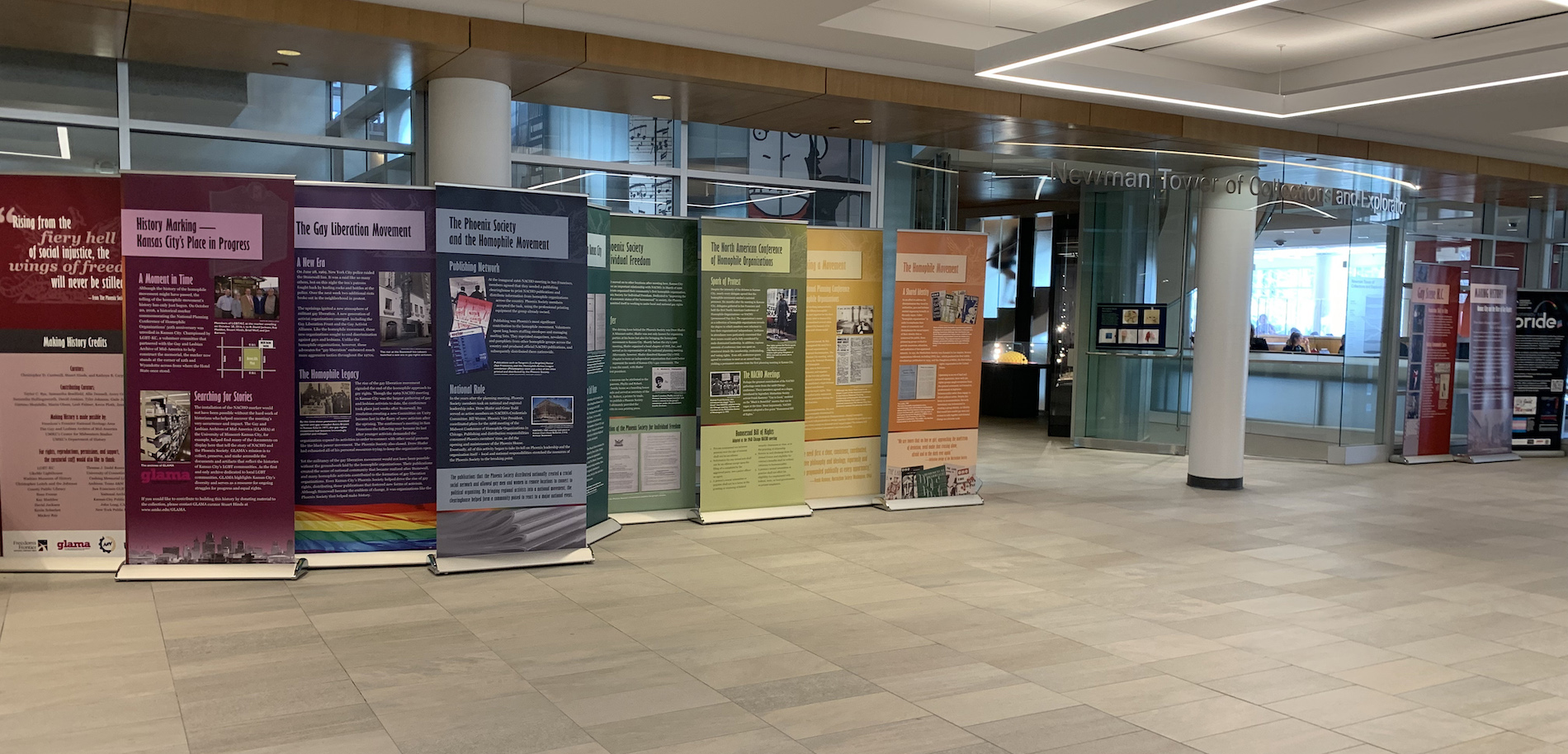 A photo of the Making History: The Rise of Gay Rights in Kansas City exhibition panels in the Olin Library lobby.