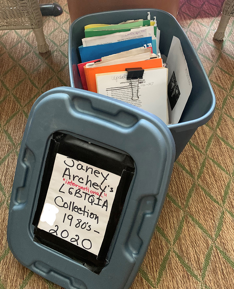 Grey box with paper folders in multiple colors. Lid reads: Janey Archey’s intersectional LGBTQIA Collection 1980s-2020