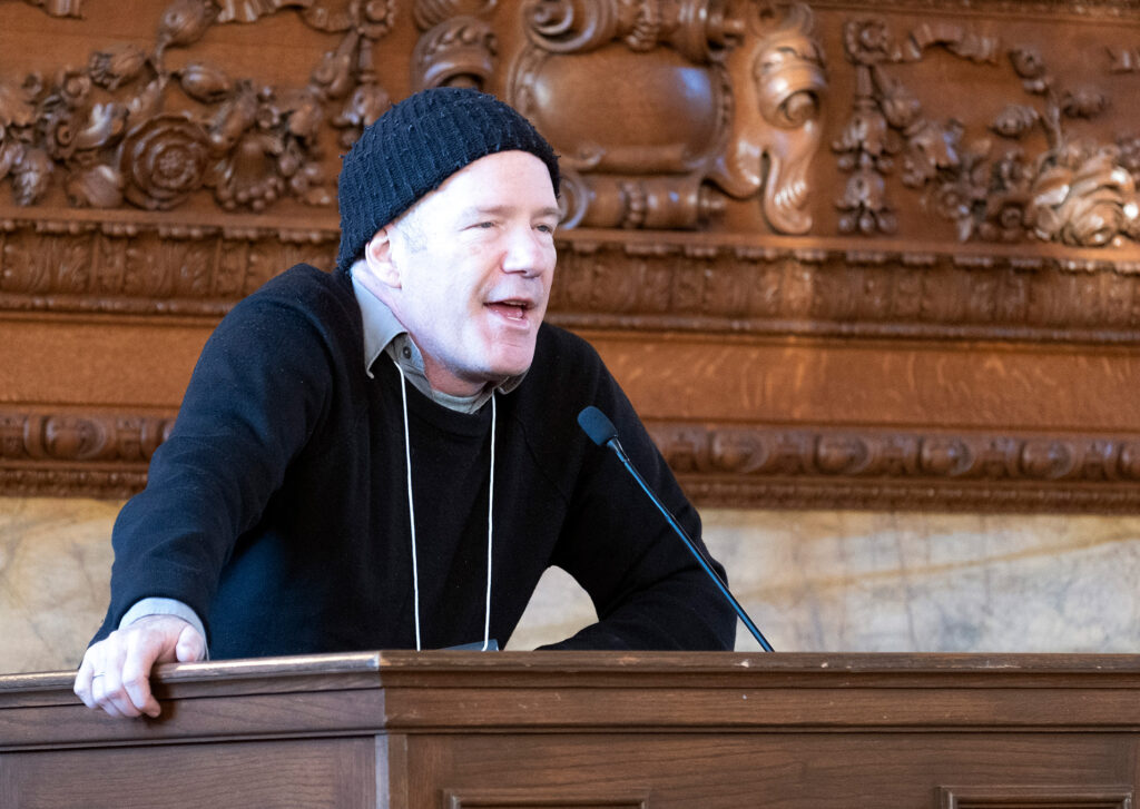 Man standing and talking behind the lectern