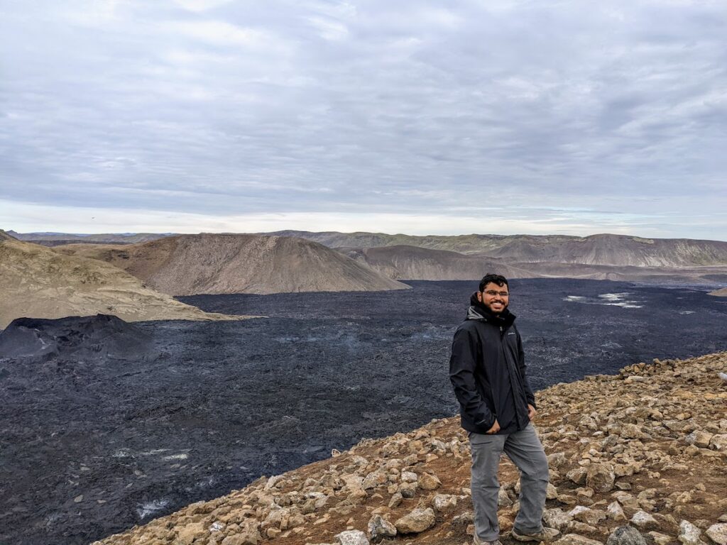 Person standing in front of volcanic rock