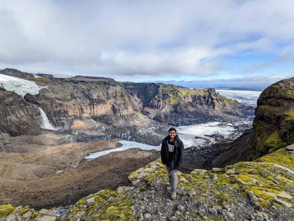 Man surrounded by mountains and rivers