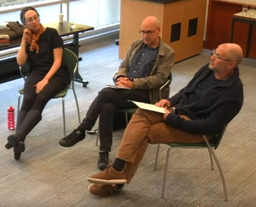 Three people sitting on chairs