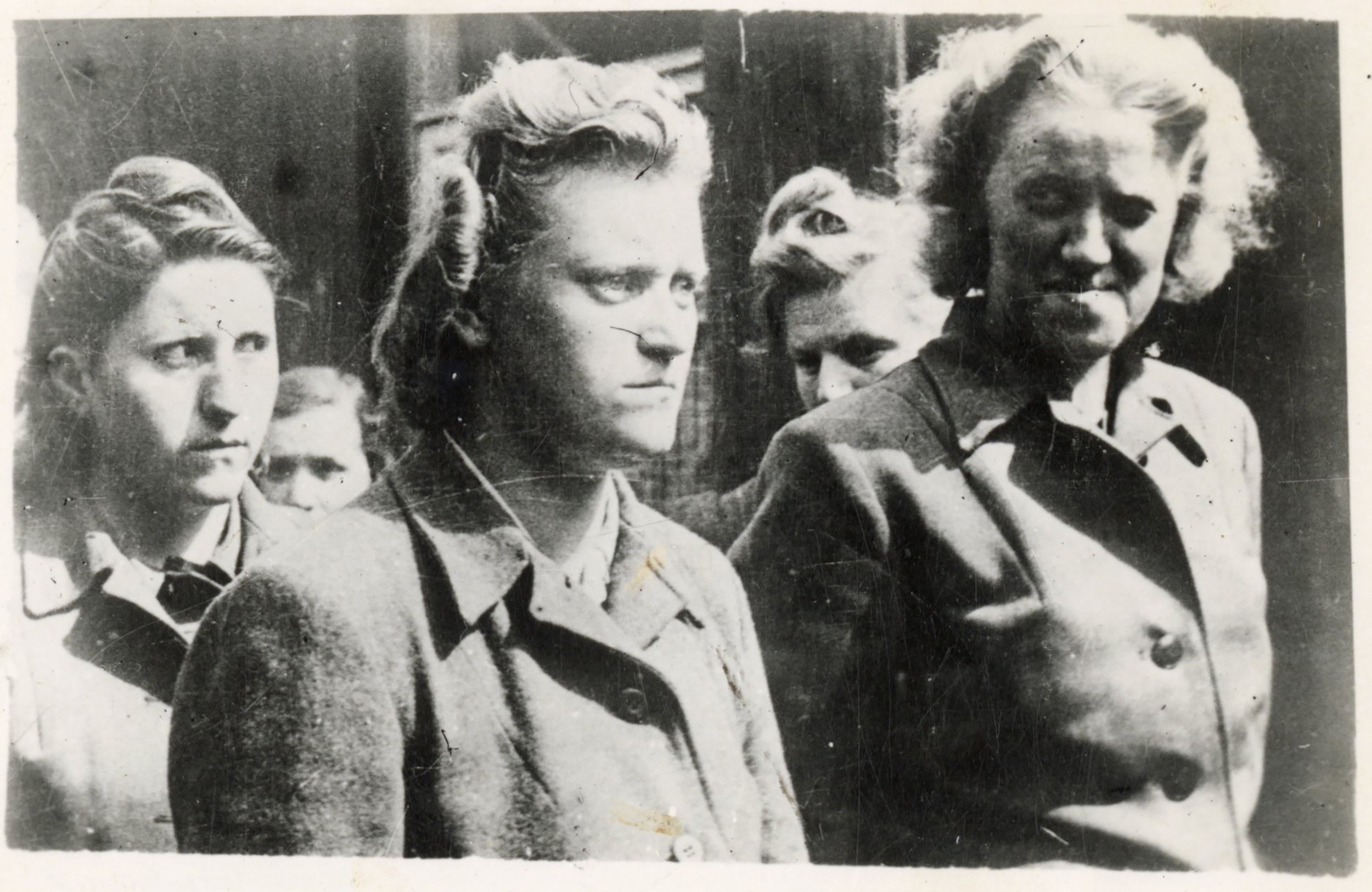 Five female guards standing in uniform at the Bergen-Belsen Concentration Camp in 1945.