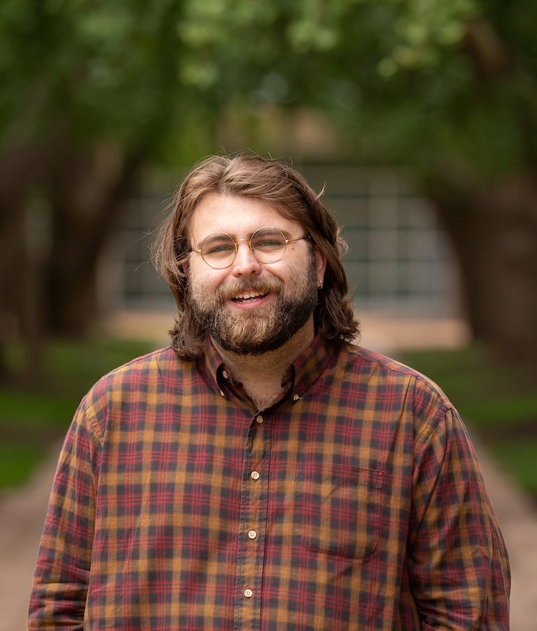 Headshot of man in striped shirt