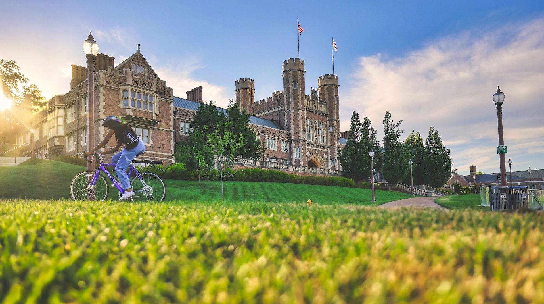 Cyclist riding past Brookings Hall