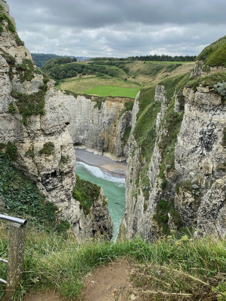 Green water surrounded by high cliffs