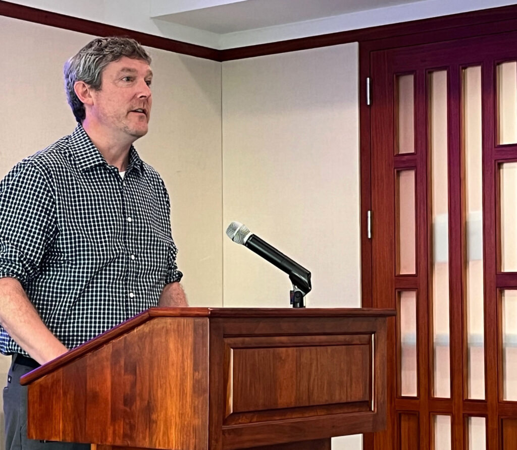 A man speaking at a lectern