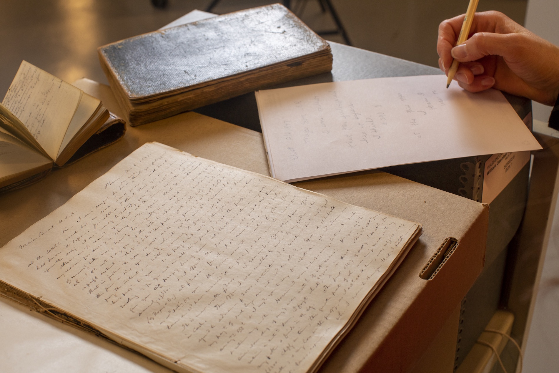 Old journals with writing on the pages.