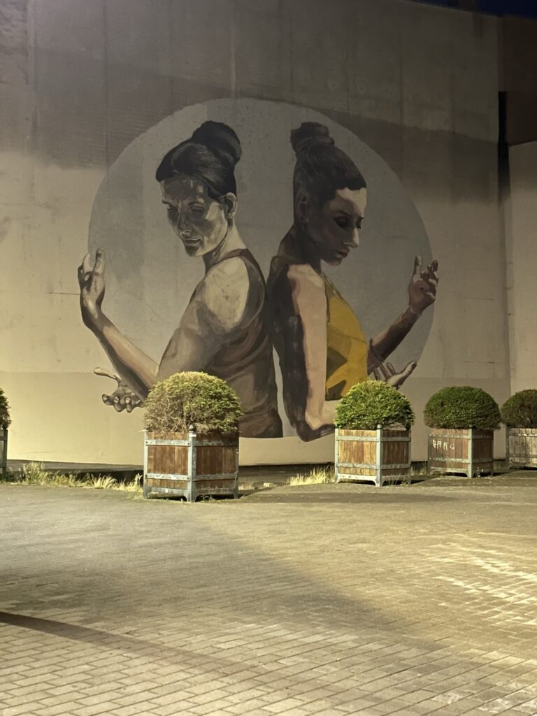 A street wall painting of two women