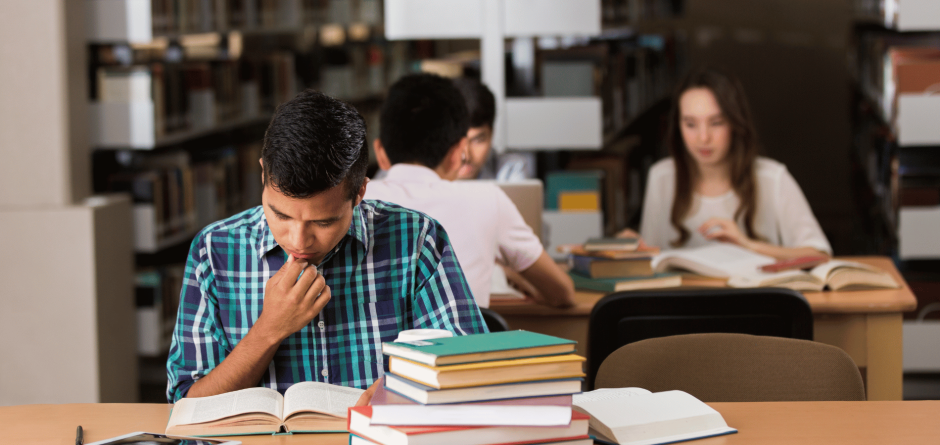 Student reading book in library