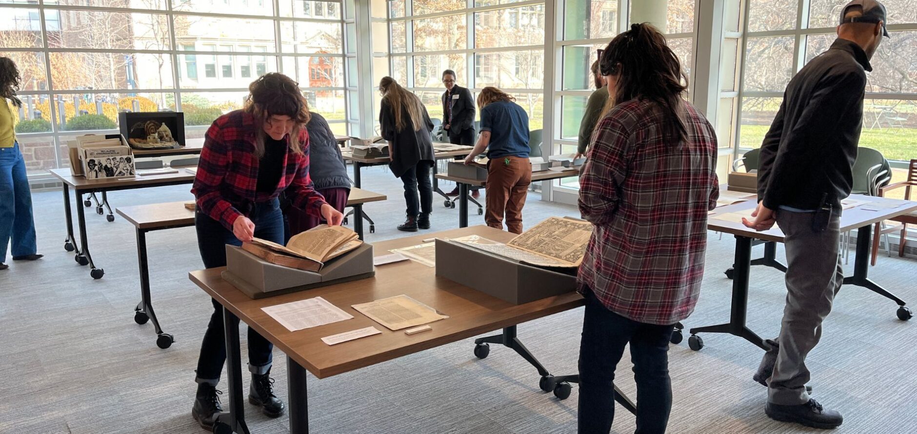 People looking at materials in the special collections reading room.