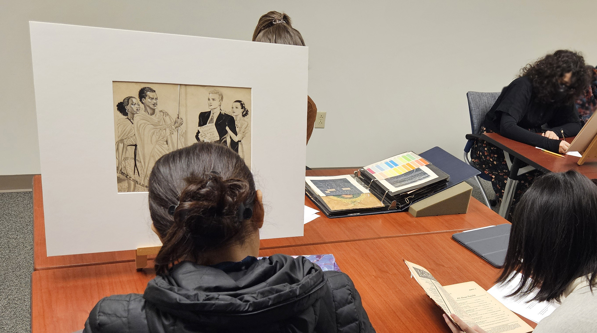 Master of Fine Arts in Illustration and Visual Culture (MFA-IVC) students investigating materials from the Dowd Illustration Research Archive (DIRA) as a part of their Exhibition & Engagement course.