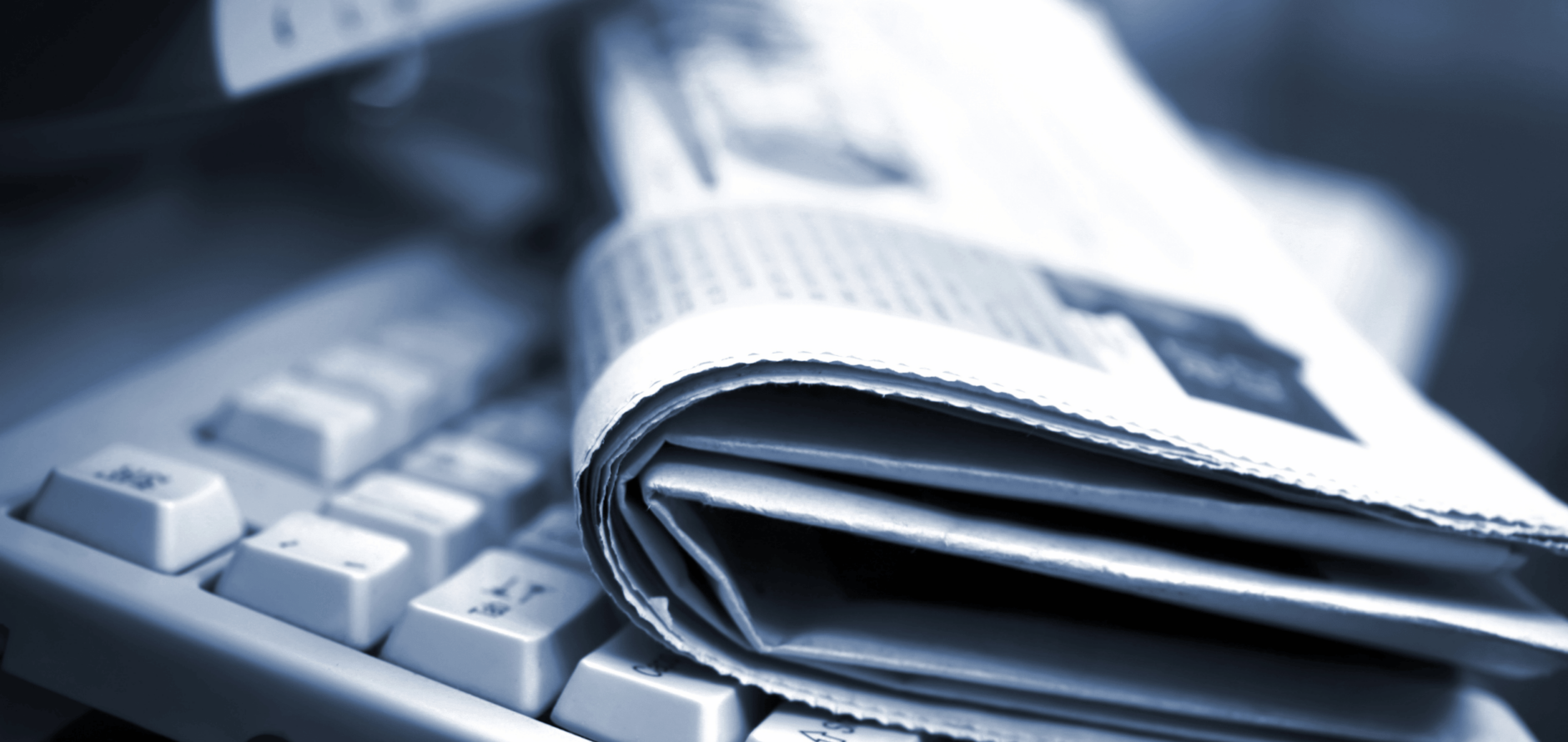 Newspaper on top of a keyboard