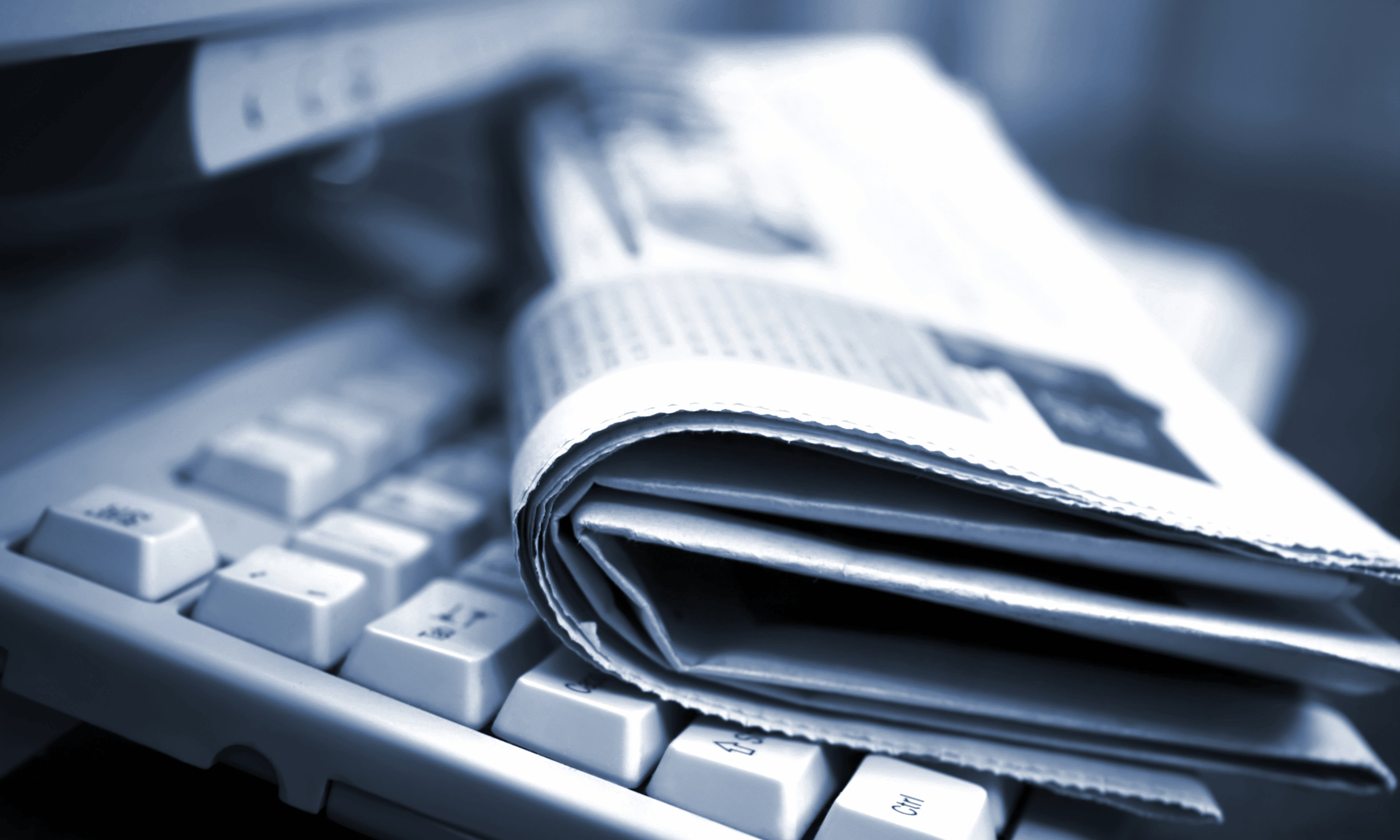 Newspaper on top of a keyboard