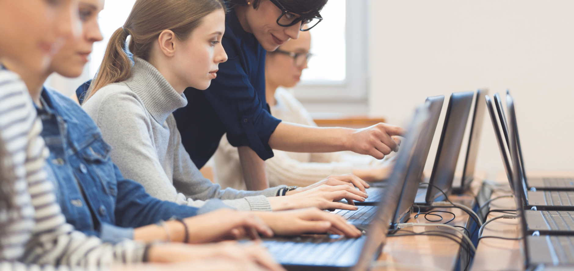 Students on computers with instructor assisting