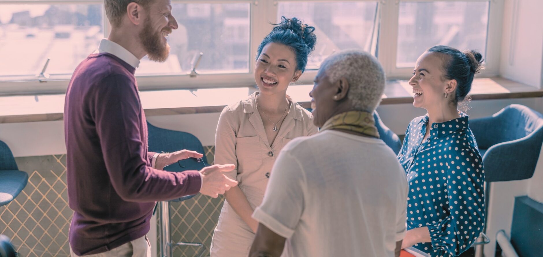 Stock photo of four adults engaged in a conversation