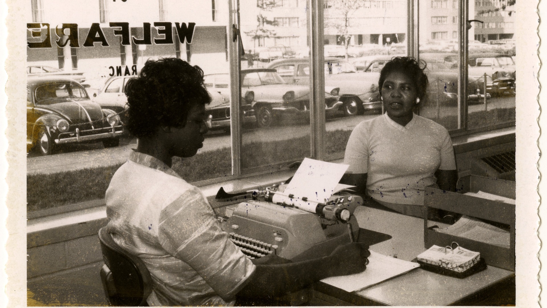 Two women in the Division of Welfare Office across from the Pruitt-Igoe public housing project