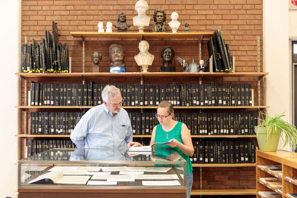 A librarian assists a patron in Gaylord Music library